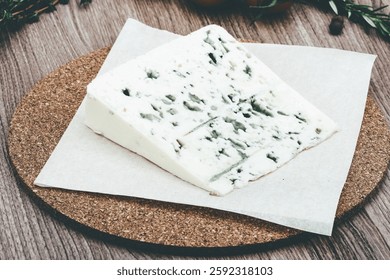 Blue cheese with herbs and spices on the wood background