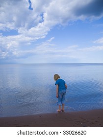 Blue child, sky, and water on the Wisconsin shore of Lake Superior