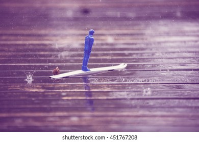 Blue Children's Ski Jumper Toy Heavy Rain On The Table In Finland. Image Includes A Vintage Effect.