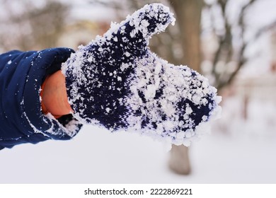 blue child's mitten in the snow