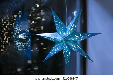 Blue Christmas Decoration And Frosty Window With Lights