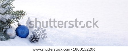 Blue Christmas decorations in the snow. Christmas panoramic banner.