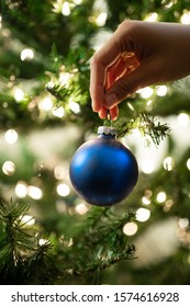 Blue Christmas Ornaments Hanging And Decorating Tree