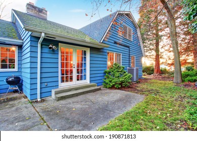 Blue Clapboard Siding House With White French Door. Backyard View