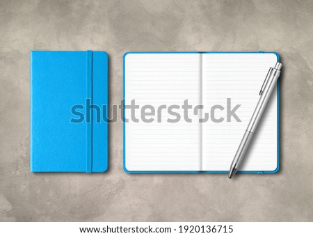 Blue closed and open lined notebooks with a pen . Mockup isolated on concrete background