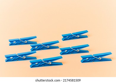 Blue Clothes Pin Isolated On Beige Background