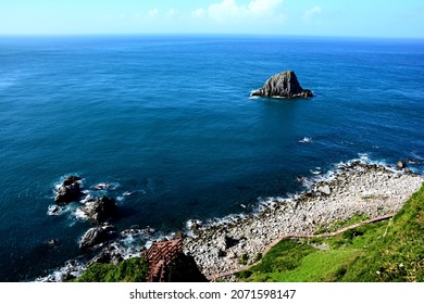 Blue coast and a triangular island.