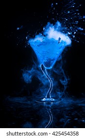 Blue Cocktail  And Dry Ice Vapor Over Black Background