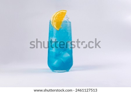 Blue cocktail in a glass on a light background. Selective focus.