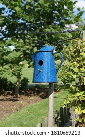 Blue Coffee Can Birdhouse In A Country Garden.