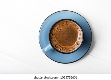 Blue Coffee Cup On A White Wood Table. Top View