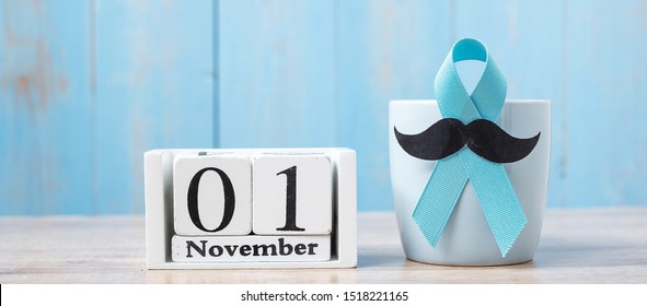 Blue Coffee Cup, Blue Ribbon, Black Mustache And 1 November Calendar.  In The Morning. Father, International Men Day, Prostate Cancer Awareness And World Cancer Day Concept