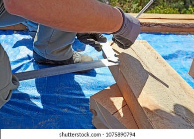 Blue Collar Carpenter Taking Measurement On Wood Plank