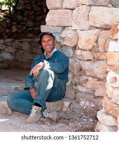 Blue Collar Worker Sitting On Construction