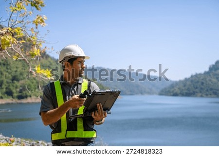 Blue collar worker is working at the dam. Environment, engineering, construction.