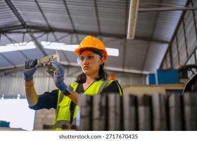 Blue collar worker is working at machine shop with CNC lathe  machine. Factory and machinery.