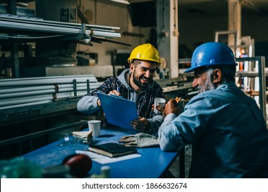 Blue Collar Workers Talking On Lunch Break At Warehouse