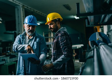 Blue Collar Workers Talking In Warehouse