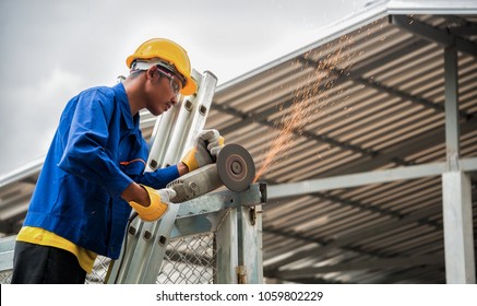 Blue Collar Workers Working In Factory