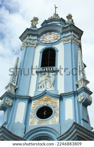 The blue color church spire with a clock of historic 18th century Durnstein Abbey in Wachau region (Austria).