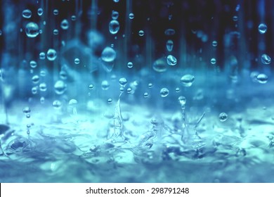 blue color tone of close up rain water drop falling to the floor  in rainy season  - Shutterstock ID 298791248