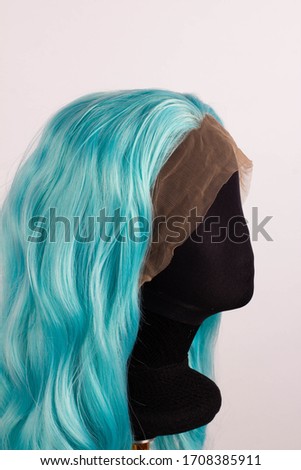 blue colored wig long curly hair on a mannequin