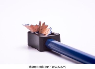 Blue coloured pencil sharpened using a sharpner