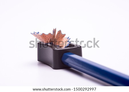 Blue coloured pencil sharpened using a sharpner