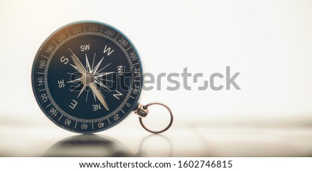 The blue compass is placed on background.