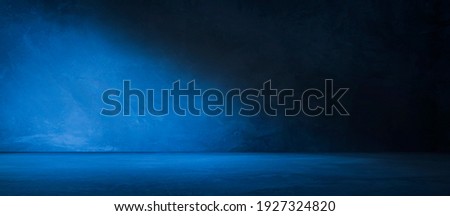 Blue concrete wall and floor with light and shadow backgrounds, use for product display for presentation and cover banner design.