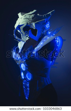 blue corset made by hand with plastic pieces and blue colored LEDs. robot of the future with space and futuristic helmet