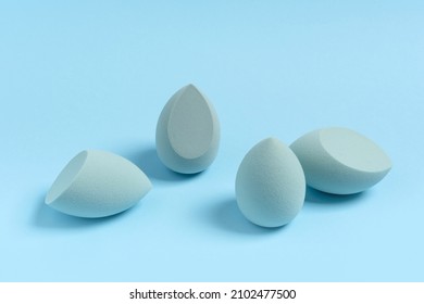Blue cosmetic makeup sponge on a minimal background. A set of sponges of different egg shapes. Tool for applying foundation cream. Nobody.