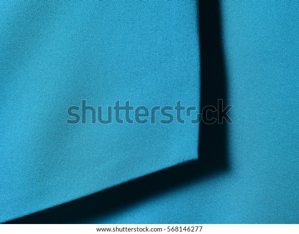 Blue cotton\
textile with shadow for\
background