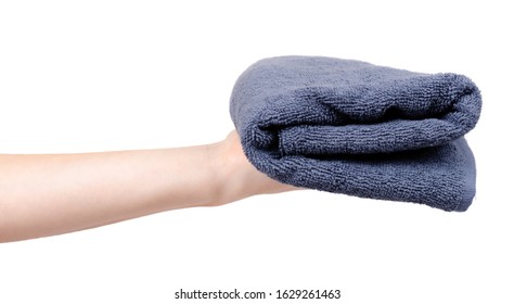 Blue cotton towel in hand. Isolated on white background.