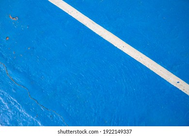 Blue Court With White Line. Empty Sport Field Photo. Hard Cover Surface For Lawn Tennis. Summer Sport Activity Outdoor. White Markup On Blue Court. Sunny Day On Tennis Court. Sport Abstraction