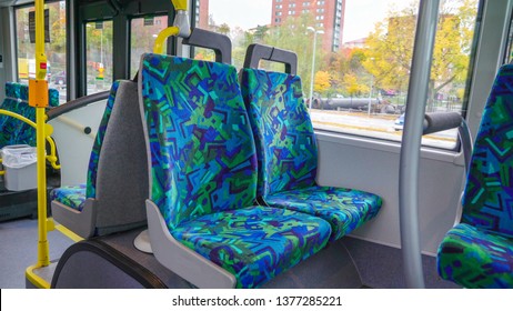 The Blue Cover Seat Of The Bus Inside That Is Empty While Travelling Along The City