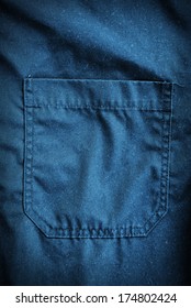 Blue coveralls pocket. Working clothes detail.