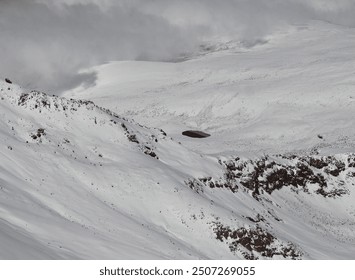 Blue crater lake in snowy mountains, Aerial view in winter. Snow-capped peaks and clear water. - Powered by Shutterstock