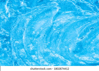 Blue Cream Texture. The Surface Of Berry Yogurt And A Smoothie Of Whipped Cream. Background Texture Of Masks And Scrubs For Face And Body. Pearlescent Silver Surface Of Blue Foam.