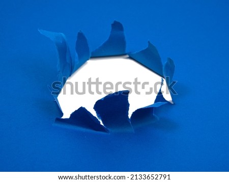 Blue crushed torn paper with hole copyspace background for idea