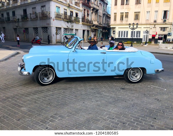 Blue Cuban vintage car. American\
classic car drives on the main road in Havana Cuba.\
10/02/2018