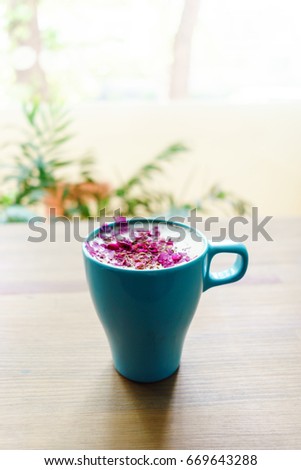 Blue cup of aroma warm cappuccino on wooden table. Relax commerce concept.