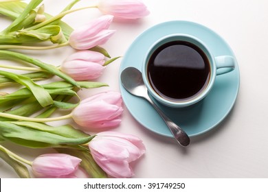 Blue Cup Of Coffee With Pink Tulip On White Background