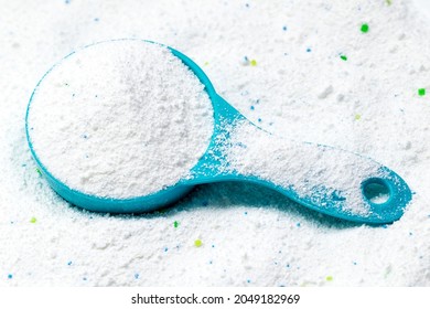 Blue Cup Or Scoop Of White Powder Detergent For Clothes Washing. Top View.