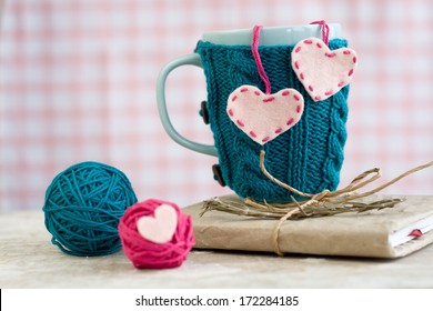 Blue cup in a blue sweater with felt hearts - Powered by Shutterstock