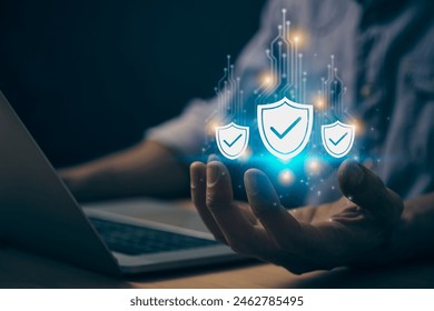 Blue Cybersecurity or Privacy Protection Concepts and Internet Security Systems. Cybersecurity Shield Icon and Circuit Line on Human Hand work with Laptop Computer in Vintage