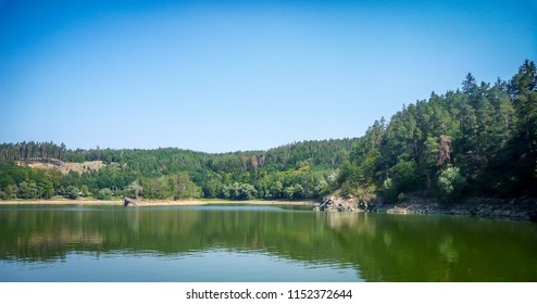 Blue dam Dalešická přehrada with green forest in beautiful valley in Czech Republic - Shutterstock ID 1152372644