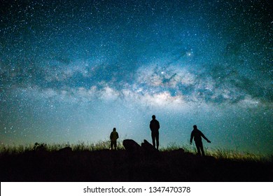 Blue Dark  Night Sky With With Star Milky Way Space Background And Silhouette Of A Standing Happy Man