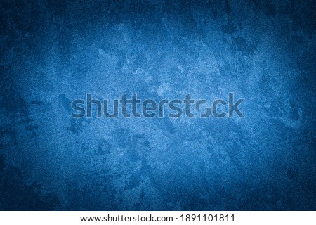 Blue decorative plaster texture with vignette. Abstract grunge background with copy space for design.