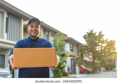 Blue Delivery asian man holding parcel cardboard box. Male employee in cap t-shirt working as courier dealer hold empty parcel box. Service and delivery concept. - Powered by Shutterstock